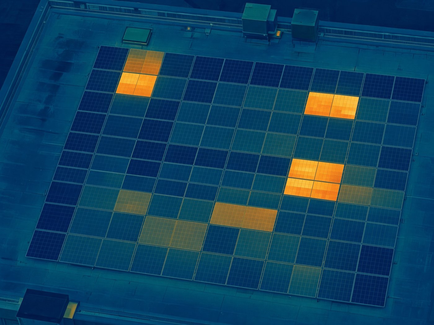 Thermal image of a rooftop solar array as a false-colour heat map.